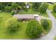 Low aerial view of this charming home with mature landscaping and a covered carport at 113 Helena St, Mount Holly, NC 28120