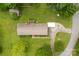 Expansive aerial view of the home with a detached carport and green lawn at 113 Helena St, Mount Holly, NC 28120