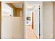 View into bathroom with mirror, wallpaper, and natural light from window at 113 Helena St, Mount Holly, NC 28120
