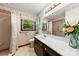 Well-lit bathroom featuring a vanity with ample counter space, tiled shower, and tasteful decor at 113 Helena St, Mount Holly, NC 28120