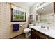 Charming bathroom with vintage wallpaper, a tiled shower, and a classic vanity, offering a nostalgic touch at 113 Helena St, Mount Holly, NC 28120