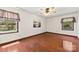 Bright bedroom with hardwood floors, ample natural light, and a ceiling fan for added comfort at 113 Helena St, Mount Holly, NC 28120