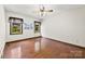 Comfortable bedroom with hardwood floors, natural light, and a ceiling fan for a relaxing space at 113 Helena St, Mount Holly, NC 28120
