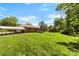 Expansive backyard featuring a well-maintained lawn and mature trees, complemented by a charming brick house at 113 Helena St, Mount Holly, NC 28120