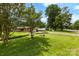 Picturesque front yard showcasing lush green grass and mature trees, offering great curb appeal and natural beauty at 113 Helena St, Mount Holly, NC 28120