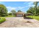 A spacious detached brick garage features a carport, providing ample parking and protection from the elements at 113 Helena St, Mount Holly, NC 28120
