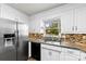 Bright kitchen featuring stainless steel appliances, granite countertops, and white cabinetry at 113 Helena St, Mount Holly, NC 28120
