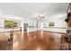 Open-concept living and dining area with hardwood floors, a fireplace, and modern appliances at 113 Helena St, Mount Holly, NC 28120