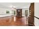 Cozy living room with hardwood floors, brick fireplace, and built-in shelving, creating a warm and inviting atmosphere at 113 Helena St, Mount Holly, NC 28120