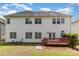 View of the white siding and wooden deck in the backyard of a two-story home at 11526 Mcginns Trace Ct, Charlotte, NC 28277