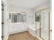 Bright bathroom featuring double vanity, soaking tub and shower with gold frame at 11526 Mcginns Trace Ct, Charlotte, NC 28277