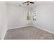 Bedroom featuring neutral carpet, ceiling fan, and natural light from windows at 11526 Mcginns Trace Ct, Charlotte, NC 28277