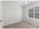 Bedroom features carpet, ceiling fan, window with blinds, and white paint at 11526 Mcginns Trace Ct, Charlotte, NC 28277