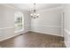 The dining room has wood flooring and a large window providing natural light at 11526 Mcginns Trace Ct, Charlotte, NC 28277