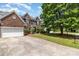 Charming brick home with attached garage, mature landscaping, and a spacious driveway at 11526 Mcginns Trace Ct, Charlotte, NC 28277