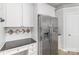 Kitchen features granite counters, stainless refrigerator, white cabinetry and wood flooring at 11526 Mcginns Trace Ct, Charlotte, NC 28277