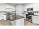 Bright kitchen with granite counters, stainless appliances, central island, and wood flooring at 11526 Mcginns Trace Ct, Charlotte, NC 28277