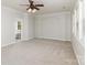 Large bedroom with neutral carpet, ceiling fan and ensuite bathroom at 11526 Mcginns Trace Ct, Charlotte, NC 28277