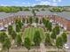 An aerial shot of a townhome community showcasing a meticulously maintained central lawn and tree-lined streets at 120F Steinbeck Way, Mooresville, NC 28117