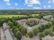 An aerial view of a charming brick townhome community with mature trees and lush green spaces and views of the surrounding area at 120F Steinbeck Way, Mooresville, NC 28117