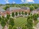 Aerial view of a well-maintained townhome community with a central green space, mature trees, and crosswalks, offering a serene living environment at 120F Steinbeck Way, Mooresville, NC 28117