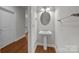 Cozy bathroom with pedestal sink, decorative mirror, and towel bar at 120F Steinbeck Way, Mooresville, NC 28117