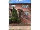 Charming brick townhouse featuring a cozy front porch and well-maintained landscaping at 120F Steinbeck Way, Mooresville, NC 28117