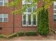Brick building featuring manicured shrubbery and double doors at 120F Steinbeck Way, Mooresville, NC 28117