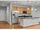 Bright, open kitchen with stainless steel appliances, island, and sleek countertops at 120F Steinbeck Way, Mooresville, NC 28117