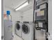 Laundry room featuring a washing machine, dryer, and water heater at 120F Steinbeck Way, Mooresville, NC 28117
