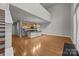 Open-concept living space with wood floors and kitchen, bathed in natural light at 120F Steinbeck Way, Mooresville, NC 28117
