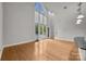 Bright, open living room featuring hardwood floors, large windows, and an open floor plan at 120F Steinbeck Way, Mooresville, NC 28117