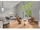 Bright open living room featuring hardwood floors, soaring ceilings, and large windows at 120F Steinbeck Way, Mooresville, NC 28117