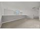 Spacious carpeted loft with arched window and neutral walls at 120F Steinbeck Way, Mooresville, NC 28117