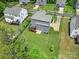 Aerial view of a home with a large yard, deck, and lush greenery, set in a tranquil neighborhood at 13222 Fiore Pl, Huntersville, NC 28078