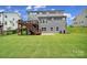 Expansive backyard featuring a wooden deck and lush green lawn, ideal for outdoor activities at 13222 Fiore Pl, Huntersville, NC 28078