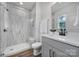 Bathroom featuring glass shower, marble look tile, white cabinets, and black hardware at 13222 Fiore Pl, Huntersville, NC 28078