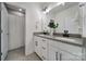 Bathroom with double sinks, neutral countertop and hardware, and tiled shower with curtain at 13222 Fiore Pl, Huntersville, NC 28078