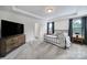 Primary bedroom with neutral color palette, lots of natural light, carpet, and large dresser at 13222 Fiore Pl, Huntersville, NC 28078