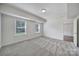 Bright, carpeted bedroom with natural light and two windows overlooking the backyard at 13222 Fiore Pl, Huntersville, NC 28078