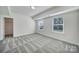 Well-lit carpeted bedroom features two windows and ample space to create your personal retreat at 13222 Fiore Pl, Huntersville, NC 28078