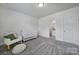 Bedroom with white crib, chair, and view into attached bathroom at 13222 Fiore Pl, Huntersville, NC 28078