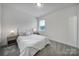 Cozy bedroom with soft carpet, natural light, and minimalist decor with a neutral color palette at 13222 Fiore Pl, Huntersville, NC 28078