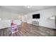 Spacious bonus room with wood floors, television, and a toy house at 13222 Fiore Pl, Huntersville, NC 28078
