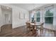 Bright dining room featuring hardwood floors, natural lighting, and a round wooden table with seating for four at 13222 Fiore Pl, Huntersville, NC 28078