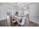 Bright dining room features stylish chandelier, hardwood floors, and ample space for entertaining guests at 13222 Fiore Pl, Huntersville, NC 28078
