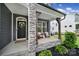 Inviting front porch showcasing stone pillars, seating, and a 'Welcome' door decor at 13222 Fiore Pl, Huntersville, NC 28078