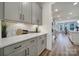 View of kitchen featuring gray cabinets, stainless steel appliances, white countertops, and hardwood flooring at 13222 Fiore Pl, Huntersville, NC 28078