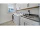 Laundry room featuring modern cabinets, a washing machine, a dryer, and sink at 13222 Fiore Pl, Huntersville, NC 28078