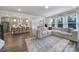 Inviting living room with an open floor plan, featuring hardwood floors and modern décor at 13222 Fiore Pl, Huntersville, NC 28078